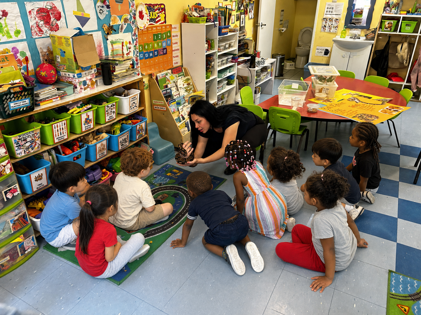 Children gathered around an educator during a classroom animal visit